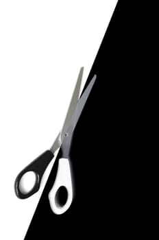 scissors cutting or dividing a black and white copyspace area