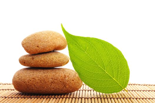 zen stone with leaf and bokeh copyspace showing spa concept