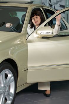 Young woman sitting in new car
