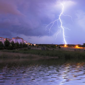 thunderstorm with lightnings and cloudy sky at rainy night