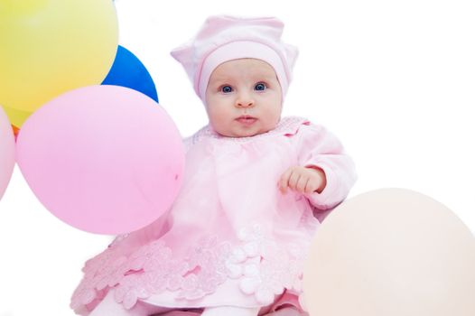 Baby girl in pink with balloons on white