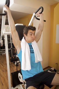 A young man exercising at gym