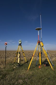 GPS unit, Total station and Prism set in the field.