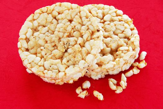 two round rice cakes over red background