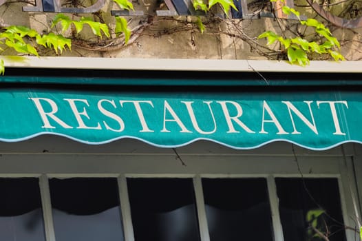 Signboard by entrance in restaurant. Paris. France