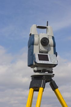 Theodolite seen against cloudy sky