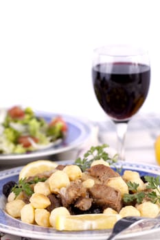 Close up view of a Portuguese meal of cooked meat with potatoes.