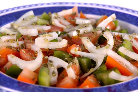Detail view of a fresh made Mediterranean salad isolated on a white background.
