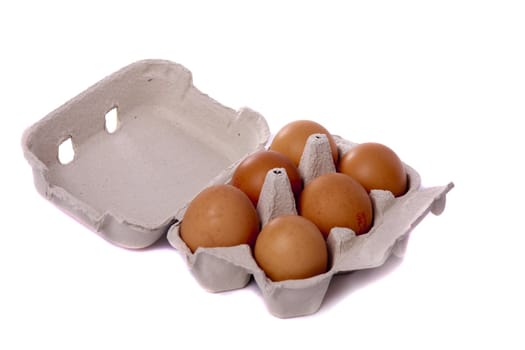 Detail view of a card box with six hen eggs isolated on a white background.