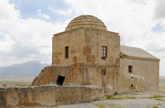 landscape and relics of disused church with dome Cappadocia Turkey, mountain backdrop, blue sky, clouds, crop area, copy area and horizontal