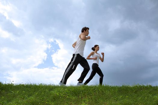 Young couple exercising in park