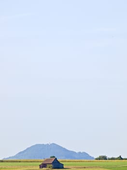 barn with a hill in the background