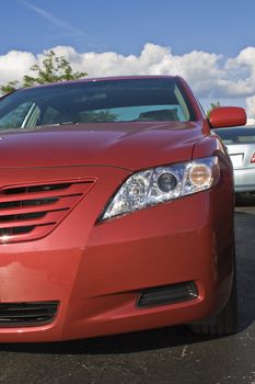 Front of a new, red Hybrid car.