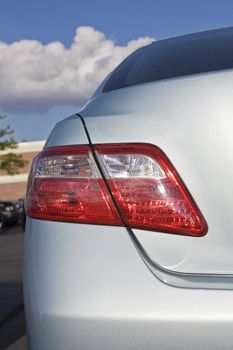 Back of a new, silver Hybrid car.