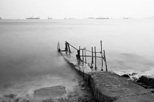 Jetty on sea at sunset