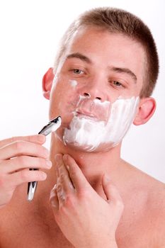 Young man with shaving foam on his face