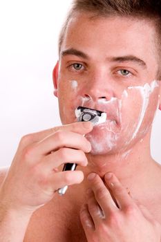 Young man with shaving foam on his face
