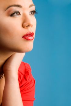 Young chinese girl on a blue background