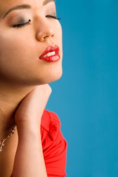 Young chinese girl on a blue background