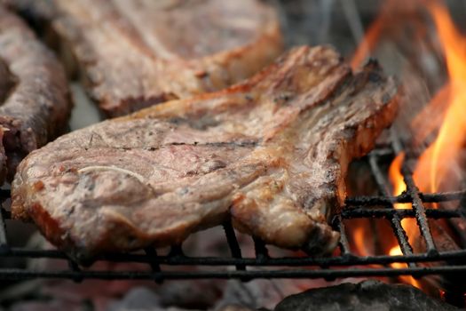 Lamb Chop grilling on open flames of a barbecue