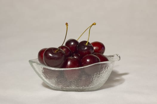 red cherry in a glass bowl