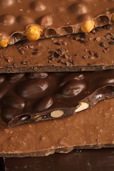 Slabs of assorted delightful chocolate goodness stacked on top of each other. Sweet!

