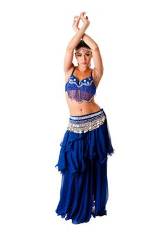 Beautiful Arabic belly dancer harem woman in blue with silver dress and head jewelry with gem dancing arms in air, isolated.