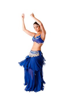 Beautiful Arabic belly dancer harem woman in blue with silver dress and head jewelry with gem dancing swirling skirt, isolated.
