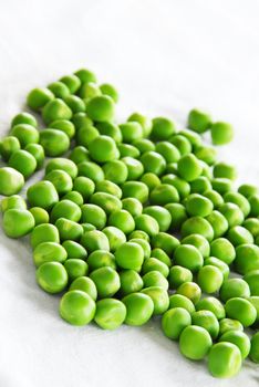 young fresh organic green spring peas scattered