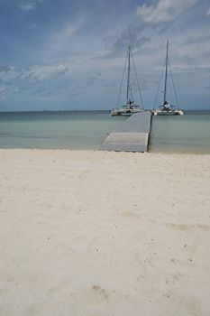 Two catamarans tied to the long landing stage