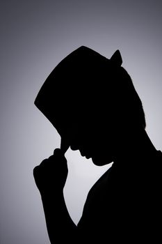 young boy is performing with hat in backlight