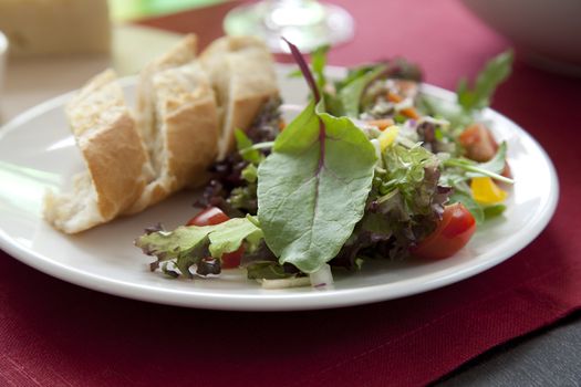 Tempting green dinner salad with fresh bread.