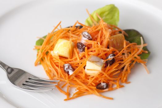 Fresh carrot salad with shredded carrots, raisins, apples and a light curry yogurt dressing.