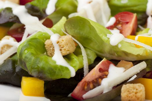 Fresh green salad with tomatoes croutons and creamy dressing.