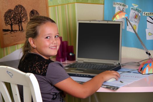 girl is sitting on her desk with a notebook