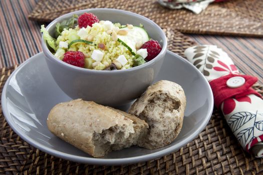Couscous salad with zucchini and raspberries and pine nuts.