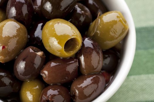 Close up of green and black Spanish olives.