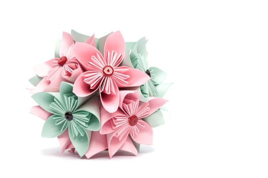Home-produced color paper flower on a white background