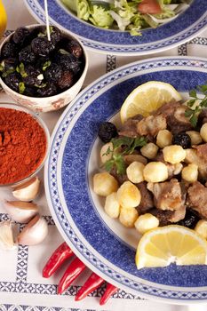 Close up view of a Portuguese meal of cooked meat with potatoes.