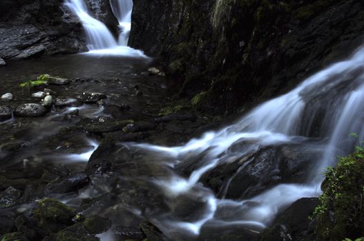 two waterfalls in the mountains