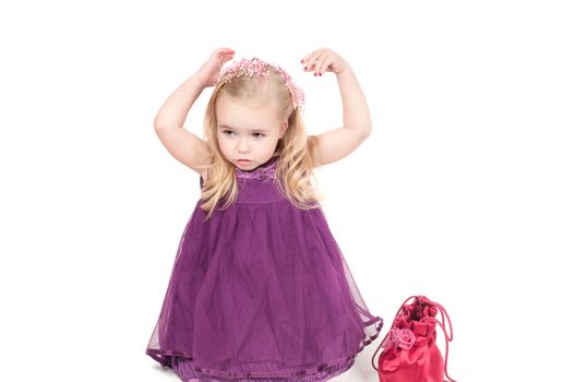 Studio shot of baby girl in lilac gala dress