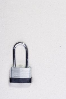 Metal lock isolated on a background of sand. 