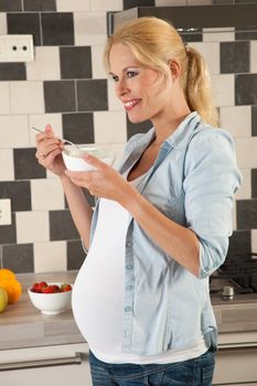 Beautiful young woman pregnant and eating healthy
