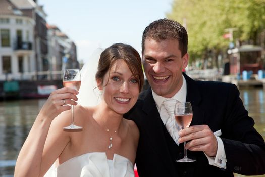 Beautiful young couple having a toast to their wedding