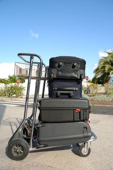 Many suitcases on a cart