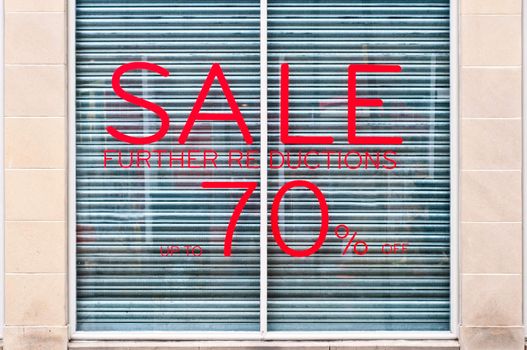 photograph of 70% sale sign on a shop windoow