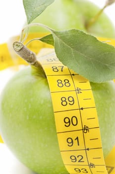 meters and apple on  white background
