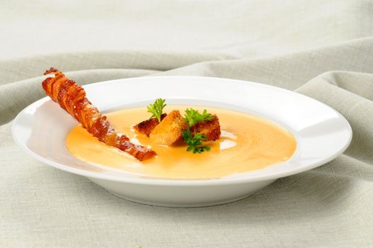 Cheddar Cheese Soup garnished with croutons and bacon.