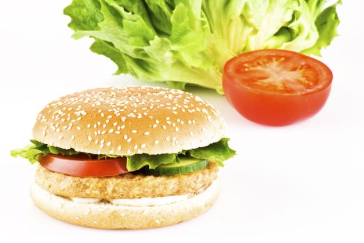 Chicken burger with tomato cucumber lettuce and mayonnaise 