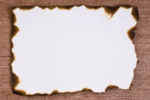 Burned paper on brown background